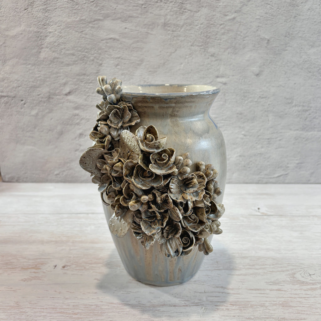 Jarrón con aplicacioenes de flores  en azules y arena