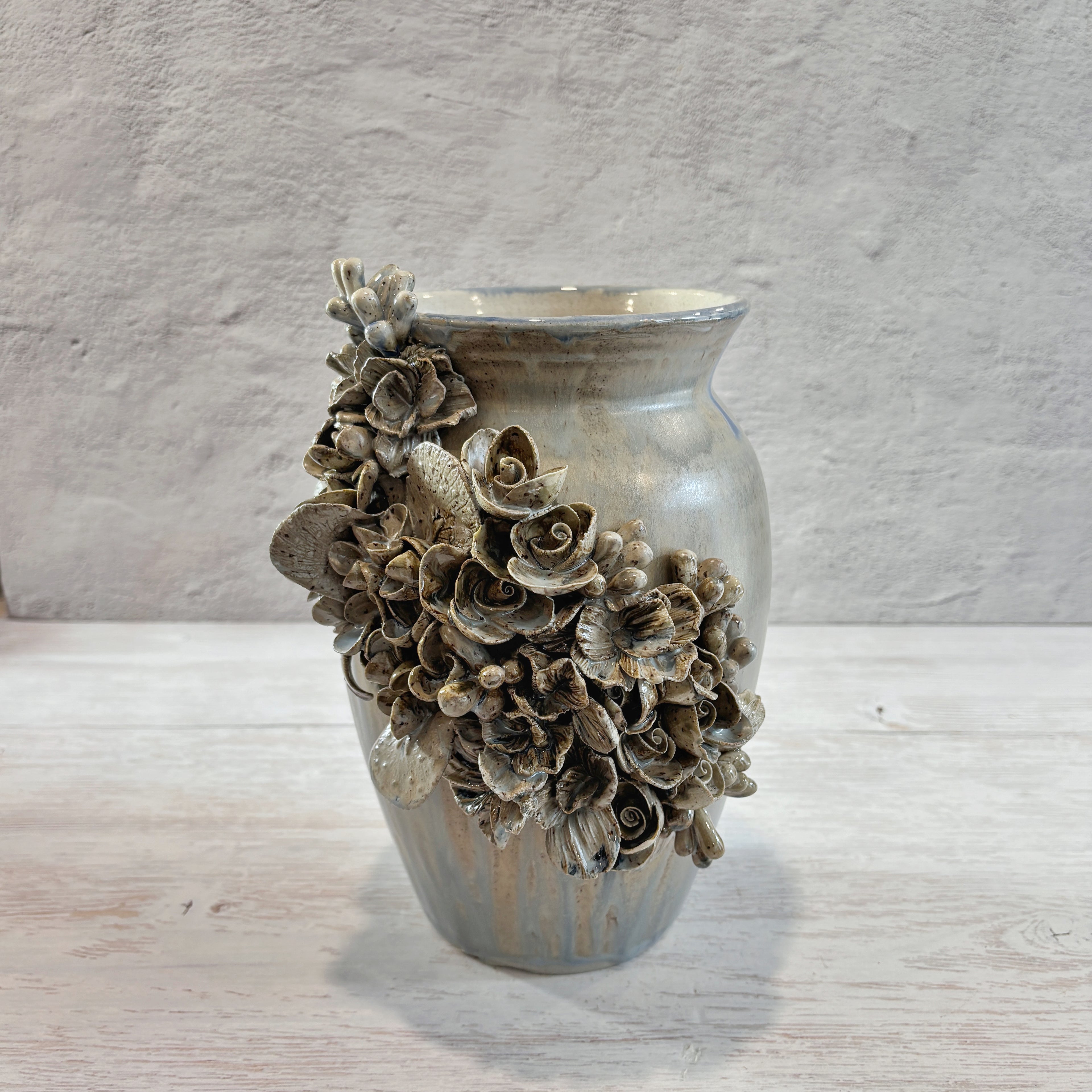 Jarrón con aplicacioenes de flores  en azules y arena